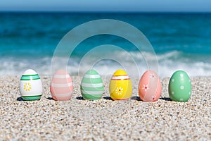 Colorful Easter eggs on the beach in sunny day.