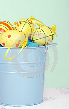 Colorful easter eggs in a blue pail