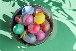 Colorful Easter eggs in bowl. Attribute of Easter celebration