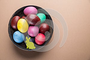 Colorful Easter eggs in bowl. Attribute of Easter celebration