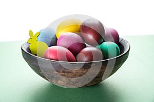 Colorful Easter eggs in bowl. Attribute of Easter celebration