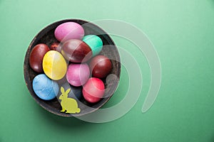 Colorful Easter eggs in bowl. Attribute of Easter celebration
