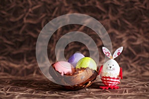Colorful Easter eggs, bowl and bunny rabbit