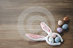 Colorful Easter eggs with bunny rabbit ears hat on wooden background  festival and holiday spring coming  Easter calibration.
