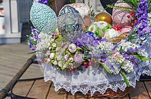 Colorful Easter eggs and Easter cakes in a wicker basket