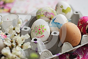 Colorful Easter eggs, in cardboard box, decorated with decoupage technique.