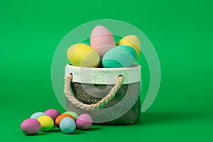 Colorful easter eggs with ceramic basket concept