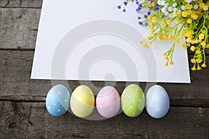 Colorful Easter eggs decoration line over wood