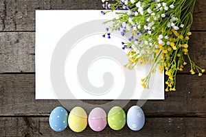 Colorful Easter eggs decoration line over wood