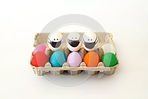 Colorful Easter eggs in egg carton on the table with copy space for text.