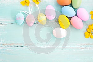 Colorful Easter eggs with flower on rustic wooden planks background