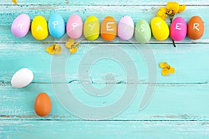 Colorful Easter eggs with flower on rustic wooden planks background in blue paint.