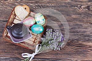 Colorful Easter Eggs with flowers and tea pot on wood