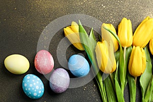 Colorful easter eggs with flowers on wooden background