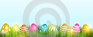 Colorful Easter eggs on fresh green grass, isolated on a light background. Space for the text. Vector