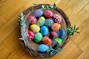 Colorful Easter eggs hand-painted at home. Using food coloring to dye Easter eggs. Painting eggs with candle wax. Getting ready