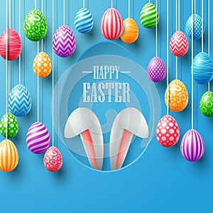 Colorful easter eggs hanging with bunny ears in egg hole on blue background