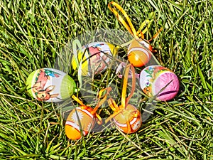 Colorful Easter eggs laying on the grass - green grassy background