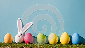 Colorful Easter eggs and lovely spring flowers on wooden background. Top view with copy space