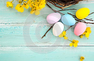 Colorful Easter eggs in nest with flower