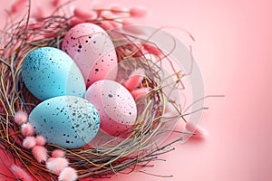 Colorful Easter eggs in a nest on pastel pink background.