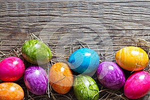 Colorful easter eggs on old wooden boards background