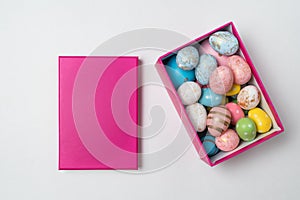 Colorful Easter eggs in pink rectangular box on white background. Happy Easter