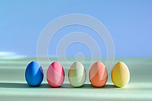 Colorful Easter eggs are standing in a row