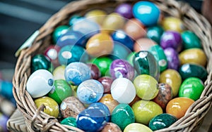 Colorful Easter Eggs in a straw basket