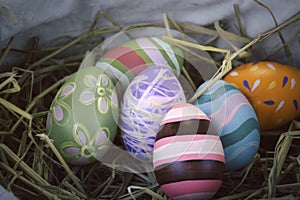 Colorful Easter eggs on on straw nest  festival and holiday spring coming  Easter calibration