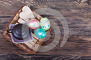 Colorful Easter Eggs with tea pot on wood