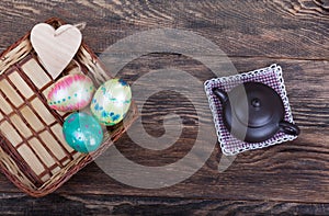 Colorful Easter Eggs with tea pot on wood