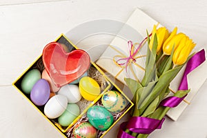 Colorful Easter Eggs and tulips decorated in beautiful giftbox