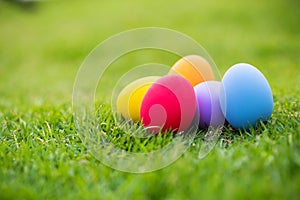 Colorful easter eggs under white mushroom on the green garden yard. symbol of easter`s day festival.