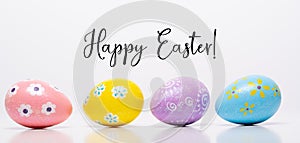 Colorful Easter eggs on white background with greeting