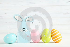 Colorful easter eggs with wooden rabbit