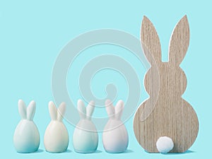 Colorful easter rabbits on blue pastel background. Easter greeting card or web border with copy space
