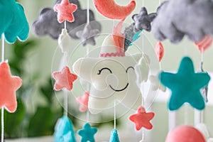 Colorful and eco-friendly children\'s mobile from felt for children. It consists of toys clouds, stars and moon. Handmade