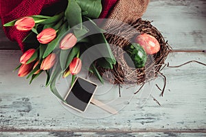 colorful eggs in the nest and tulips