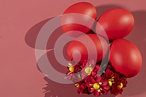 Colorful eggs, symbolizing Easter, on a colorful background and flowers