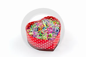 Colorful elastic rainbow loom bands in gift box shaped heart.