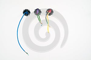 Colorful electrical cables hanging from the ceiling in spirals and bundles