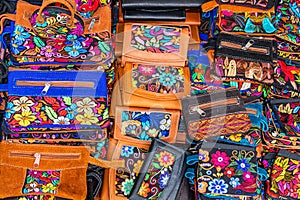 Colorful embroidered textile and leather wallets from Otavalo, Ecuador