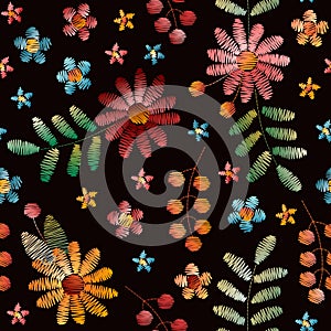 Colorful embroidery seamless pattern. Bright flowers, leaves and berries on black background. Beautiful fancywork photo