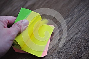 colorful notebook in hand with wooden background