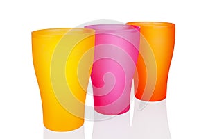 Colorful empty plastic cups white background isolated closeup, three disposable blank drinking glasses, beverage, cocktail