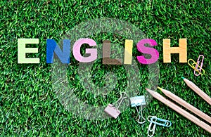 Colorful ENGLISH word cube on green grass yard background ,English language learning concept