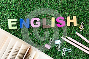 Colorful ENGLISH word cube on a green grass yard  background ,English language learning concept