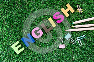 Colorful ENGLISH word cube on a green grass yard  background ,English language learning concept