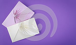 Colorful envelopes on purple background. Top view